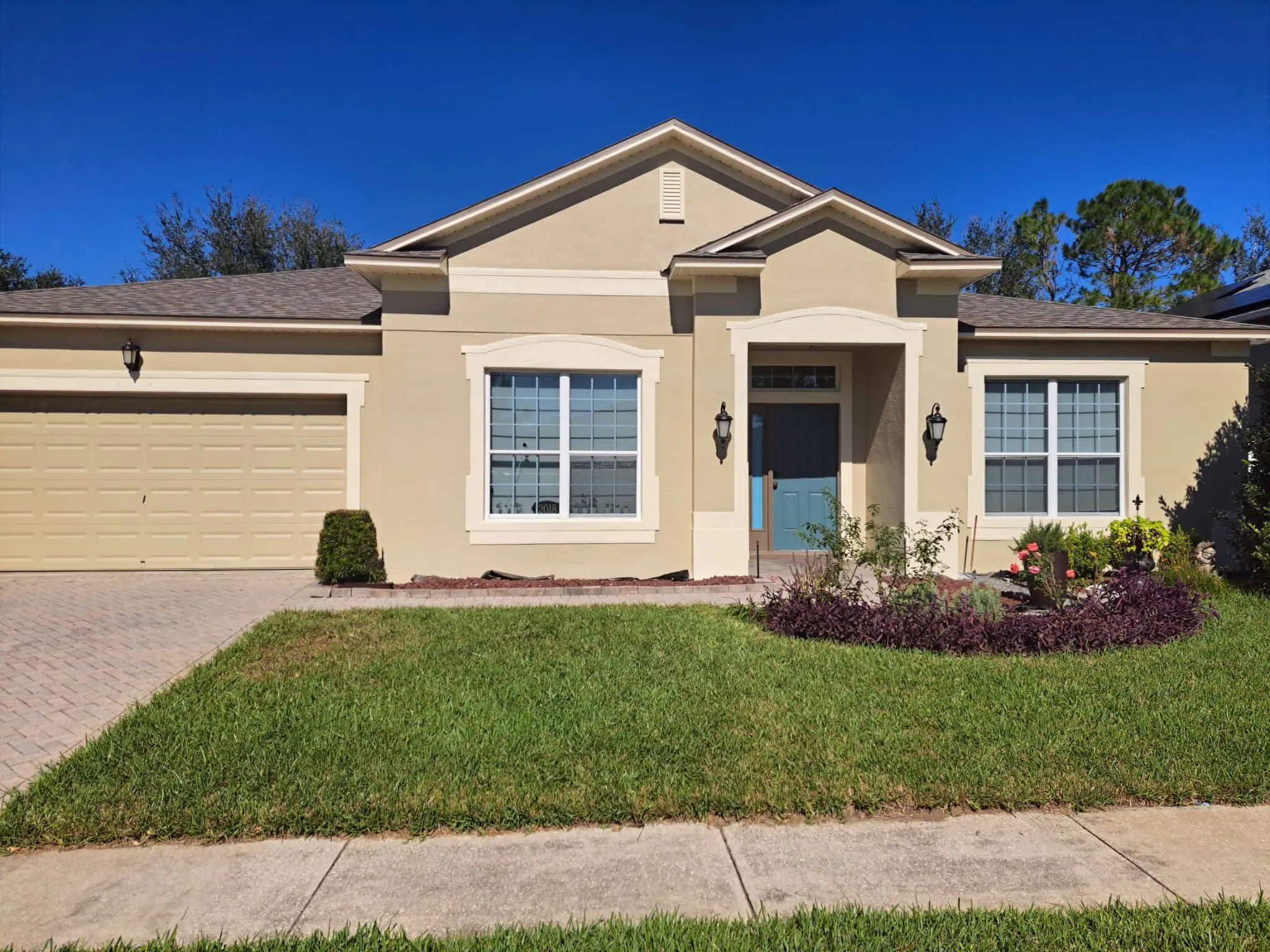 Alt Text: After exterior coating project showing refreshed stucco home in Orlando Florida