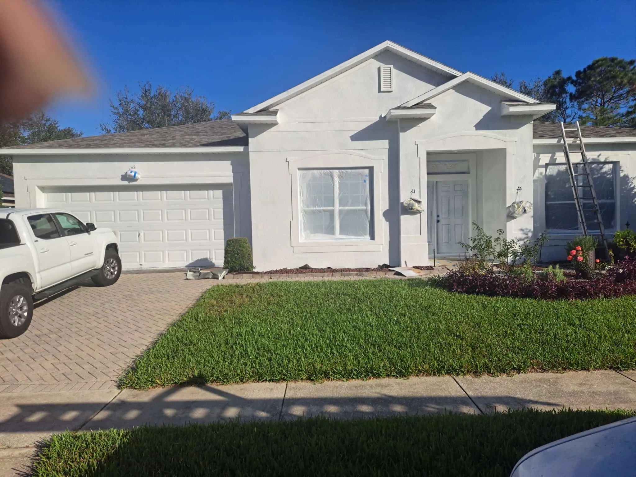 Before exterior coating project showing white stucco home in Orlando Florida